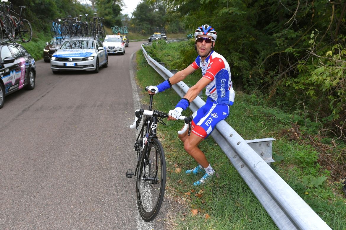 Thibaut Pinot waits for a bike change