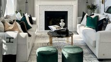 A small living room with black, white, and green luxe furniture and decor