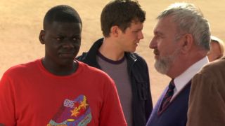 Daniel Kaluuya in Doctor Who with two poeple standing behind him.