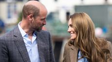 Prince William and Catherine, Princess of Wales look happily at each other during a visit to a local market on April 29, 2025 in Tobermory, Scotland