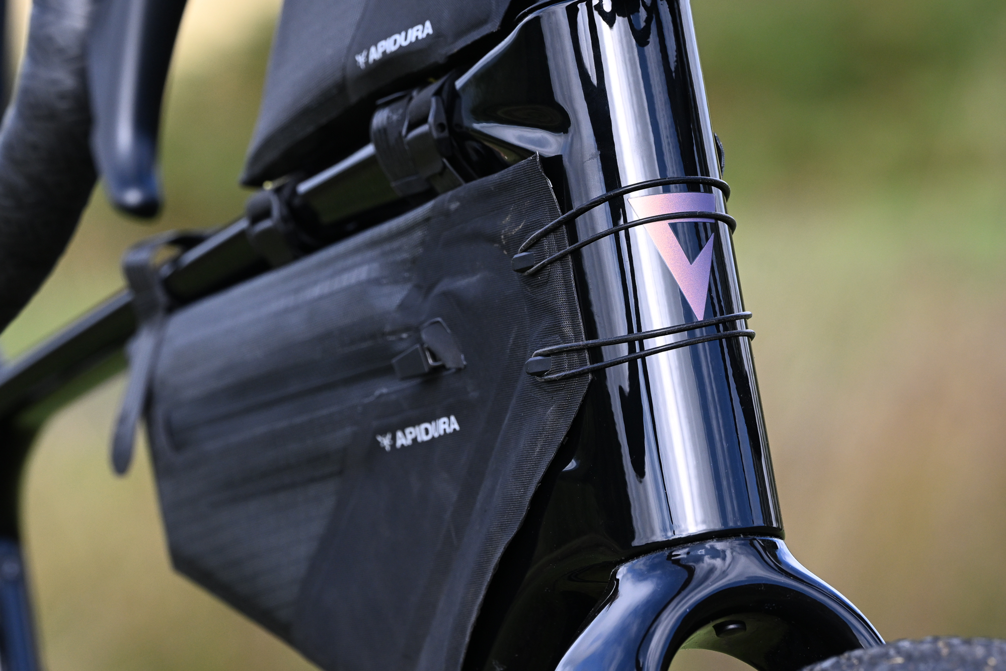 close up of a black frame bag attached to a black gravel bike