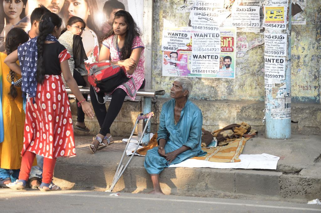 An Indian begger sits on the side of the road in Hyderabad on November 10, 2017. 