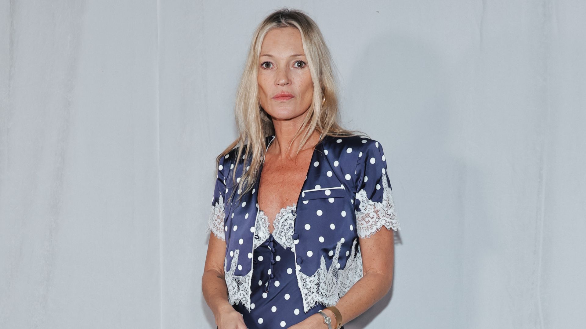 Katre Moss wears a polkadot midi dress with heeled lace-up boots.