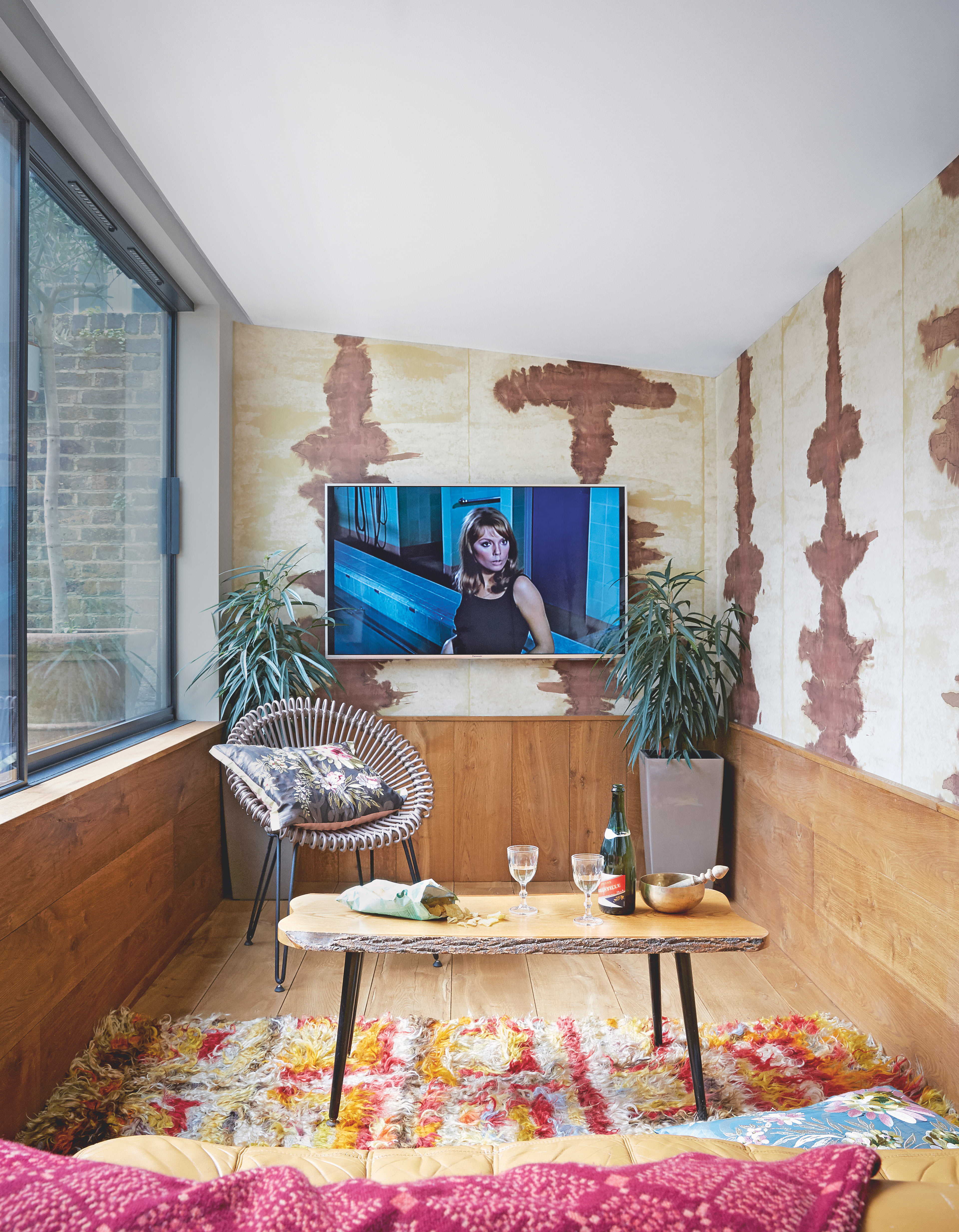 Small wooden clad living room with TV