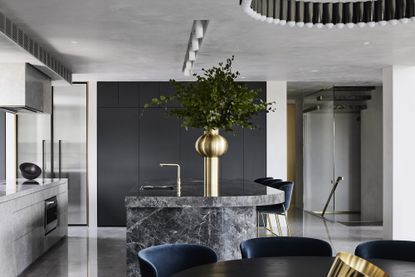 kitchen with stone and sleek contemporary surfaces at Curatorial House in Melbourne