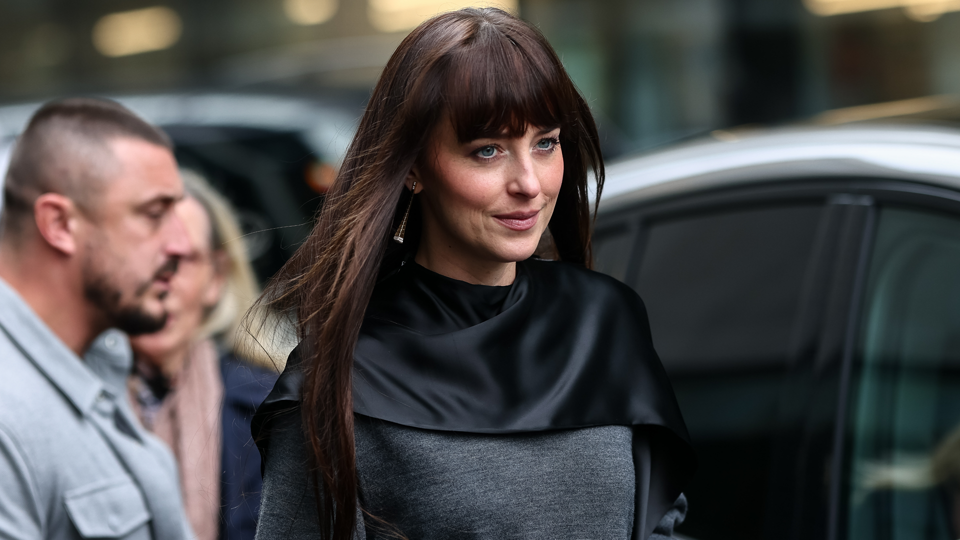 Dakota Johnson was spotted in L.A. wearing a brown wrap coat and black knee-high boots