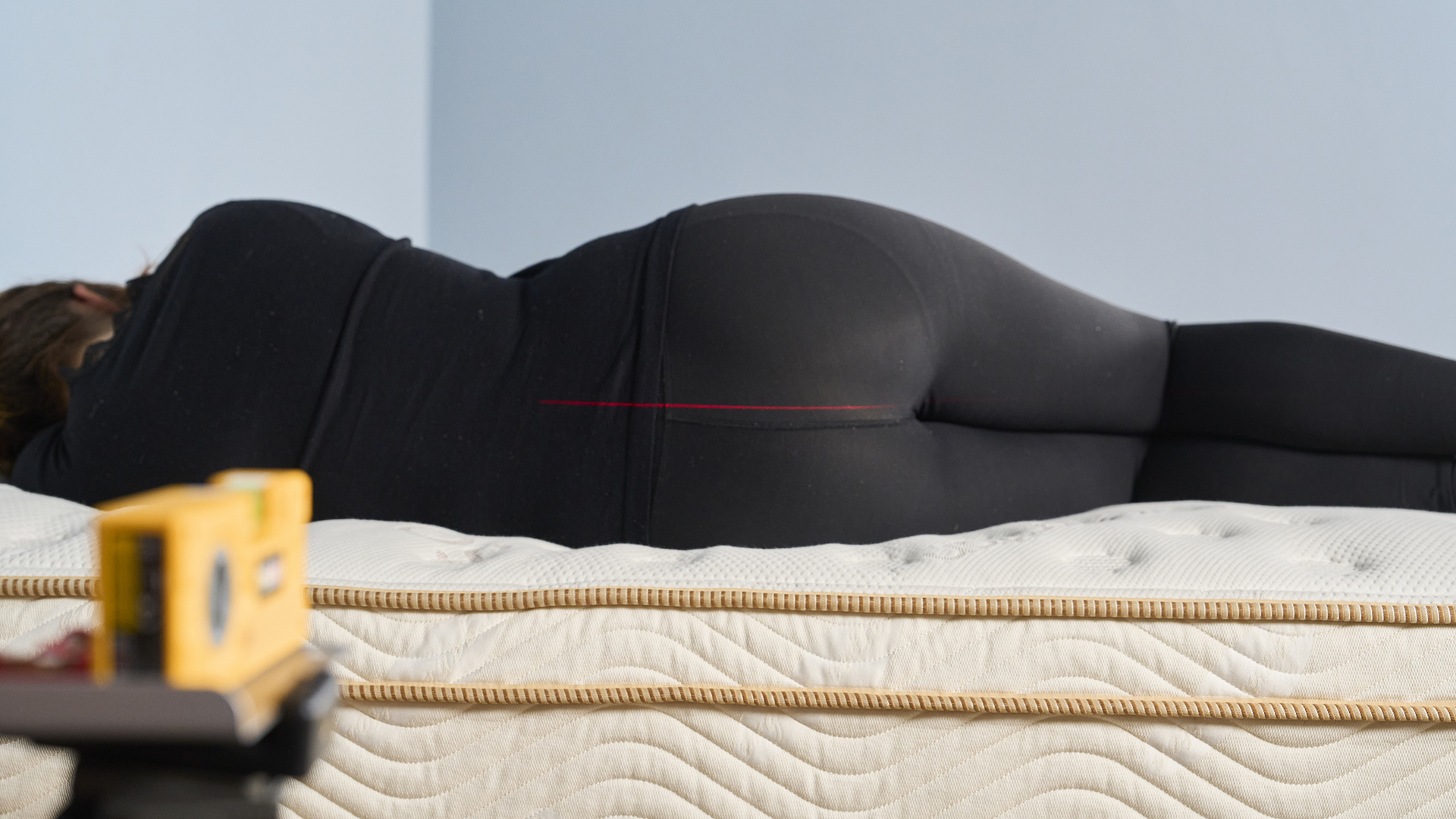 Tom&#039;s Guide mattress tester Lauren Jeffries lies on her side on the Saatva Classic mattress. We use our digital laser measure to trace a straight line down the centre of her back so that we can see instantly if there&#039;s any dipping that might cause her spine to move out of healthy alignment. The Saatva Classic excels at pressure relief and this strong support is one of the reasons why.