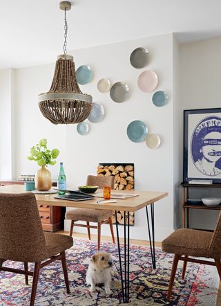 Dining room with plate gallery wall and large patterned area rug