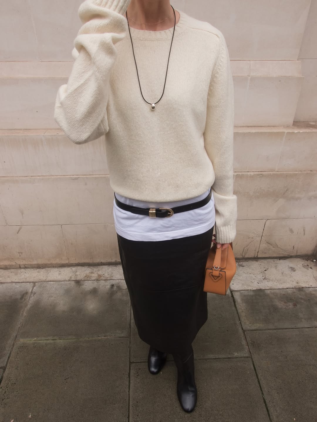 Woman wearing layering outfit idea 2026.