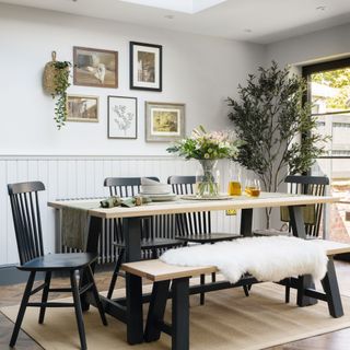 black chairs and black and wooden bench and table in dining area