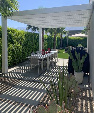 modern pergola and dining set up in backyard