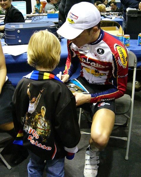 Keisse signs away for a young fan who already has the jacket bearing his name