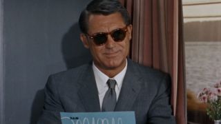 Cary Grant smiles while considering a menu through his sunglasses in North by Northwest.