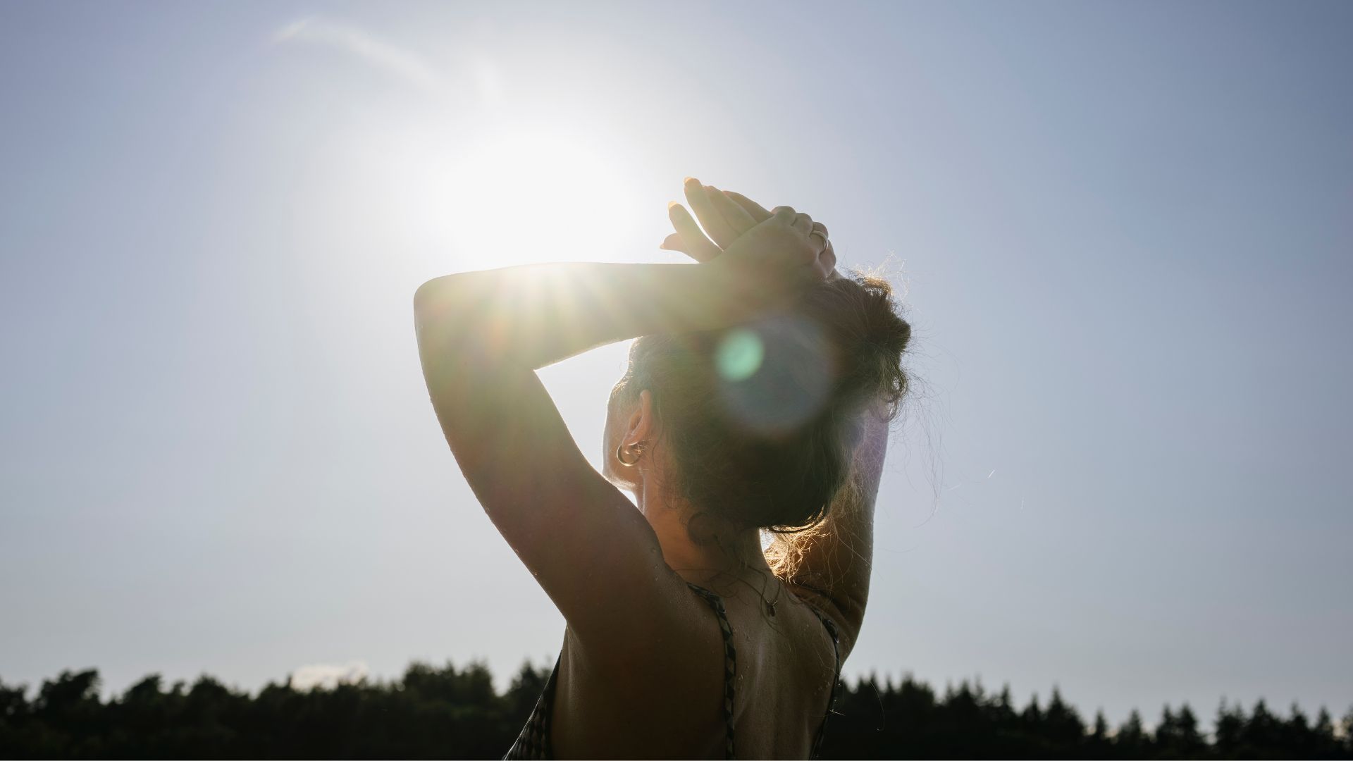 Woman looking up at the sun
