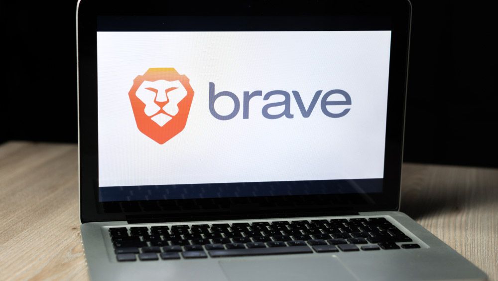 The Brave web browser logo displayed on the screen of a MacBook.