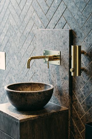 stone basin and brass bathroom tap