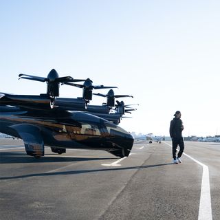 Midnight eVTOL aircraft by Archer Aviation on tarmac, person walking by