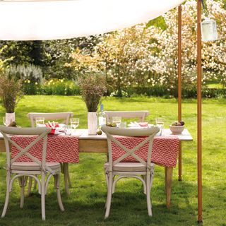 A sail awning and table and chairs outdoors
