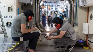 Members of the upcoming Expedition 66/67 during a fire exercise inside a mock-up of the International Space Station.