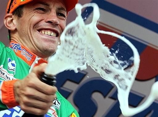 Sella pops the cap on the champagne after his third stage win.