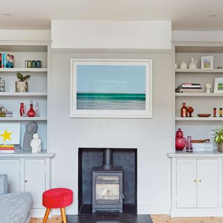 grey living room with wood burner and shelves