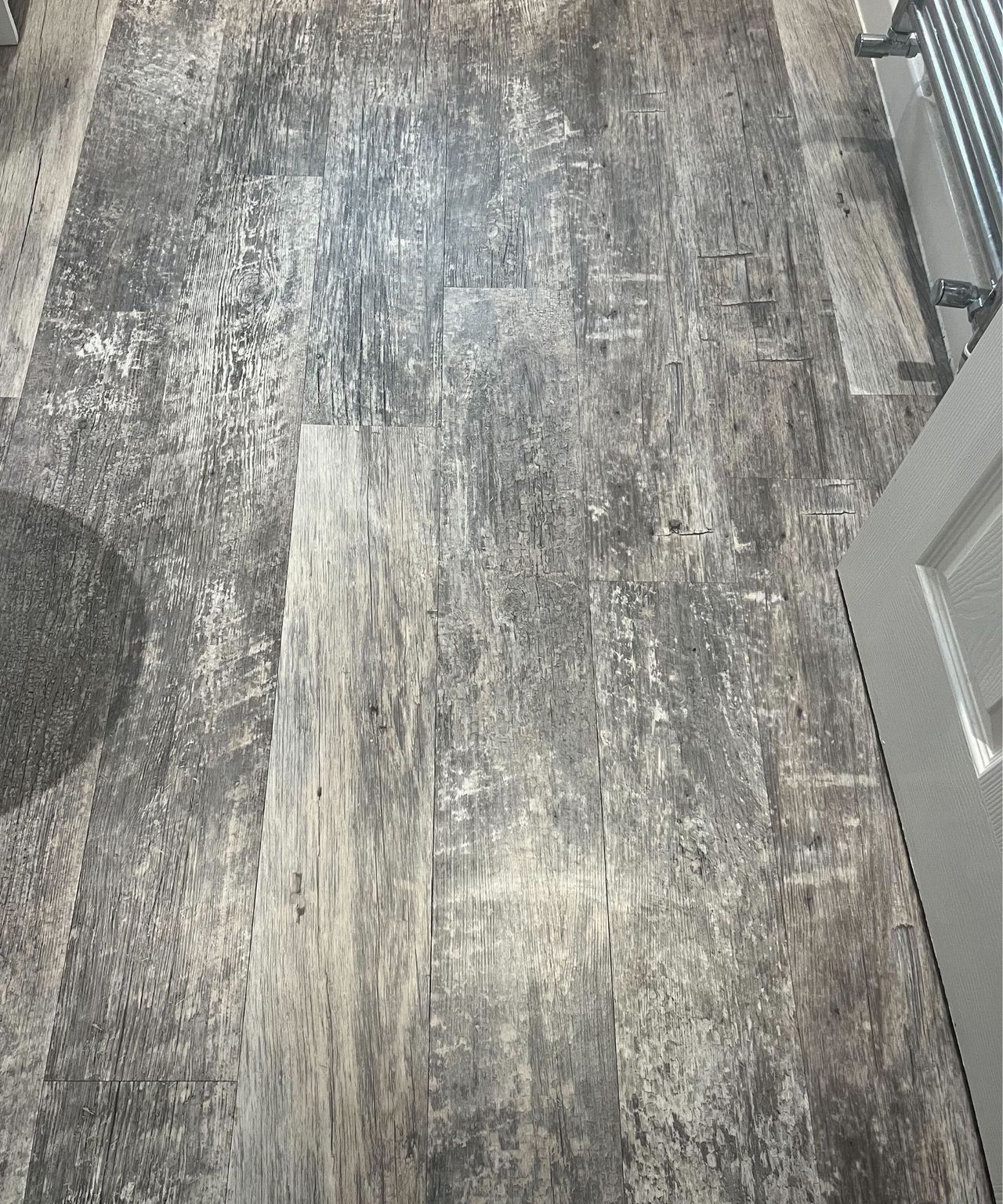 The gray bathroom floor looking clean after mopping
