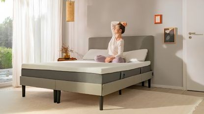 An Emma Original mattress on a grey fabric bed