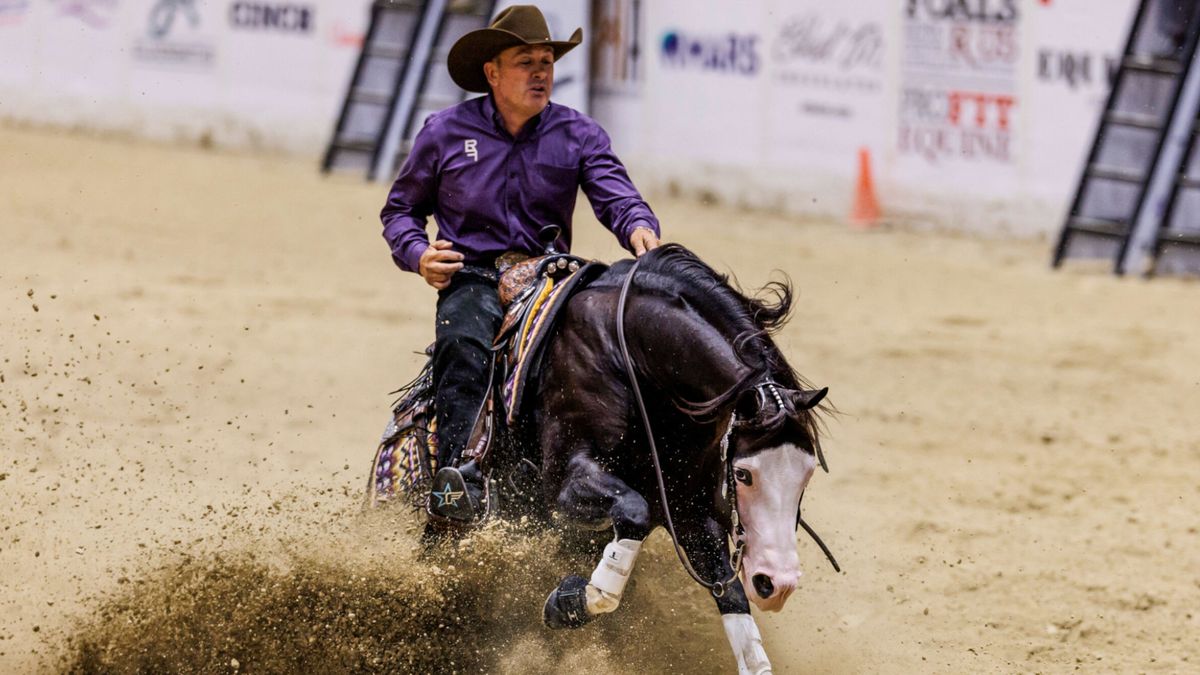 A horse-reining champion rides a horse as part of