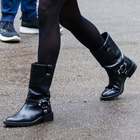 a woman at fashion week wearing a pair of Ganni moto boots at fashion week