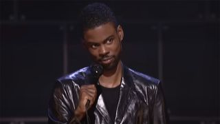 Chris Rock in his cool black jacket onstage in Bigger & Blacker.