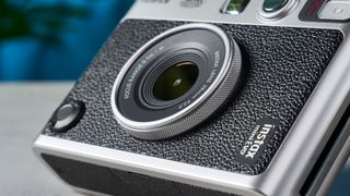 A close-up shot of a Fujifilm Instax mini Evo's lens