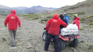 Researchers carry the plaster jacket containing the Stegouros elengassen specimen to their campsite in subantarctic Chile.