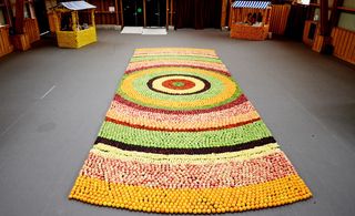 geometric carpet of fresh fruit. Surrounding this was a series of bars serving raw organic juices