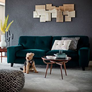 living area with green sofa and dog