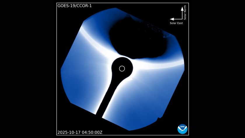 A black shadow is seen at the top right of the image with a blue halo of light in the middle where the coronagraph is