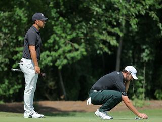 Xander Schauffele and Patrick Cantlay reading a putt at the Zurich Classic Of New Orleans