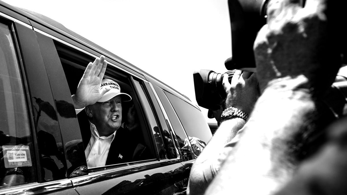 LAREDO, TEXAS - JULY 23: Republican Presidential candidate and business mogul Donald Trump talks to media from his car wearing a, "Make America Great Again," hat during his trip to the border