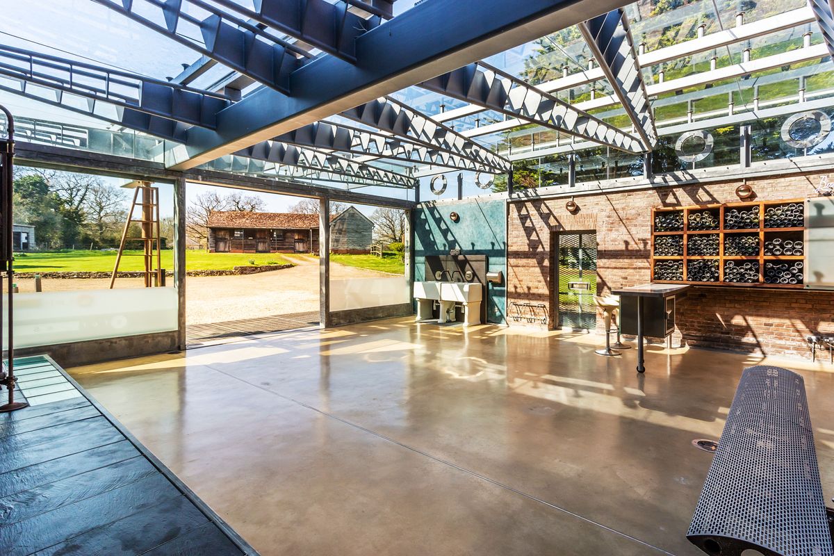 A conservatory with large steel beams above and large open door