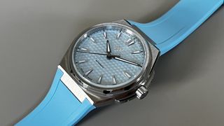 The Christopher Ward The Twelve 36mm in Blue on a grey background