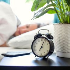 woman sleeping in bedroom with plant