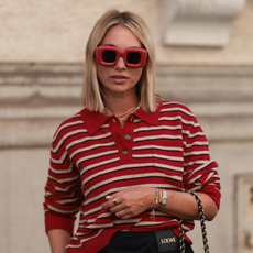 Post-summer hair repair Karin Teigl seen wearing Loewe red oversized square sunglasses, Baum & Pferdgarten red-and-white striped long-sleeve polo sweater, colorful playful beaded necklaces including a cherry pendant, 