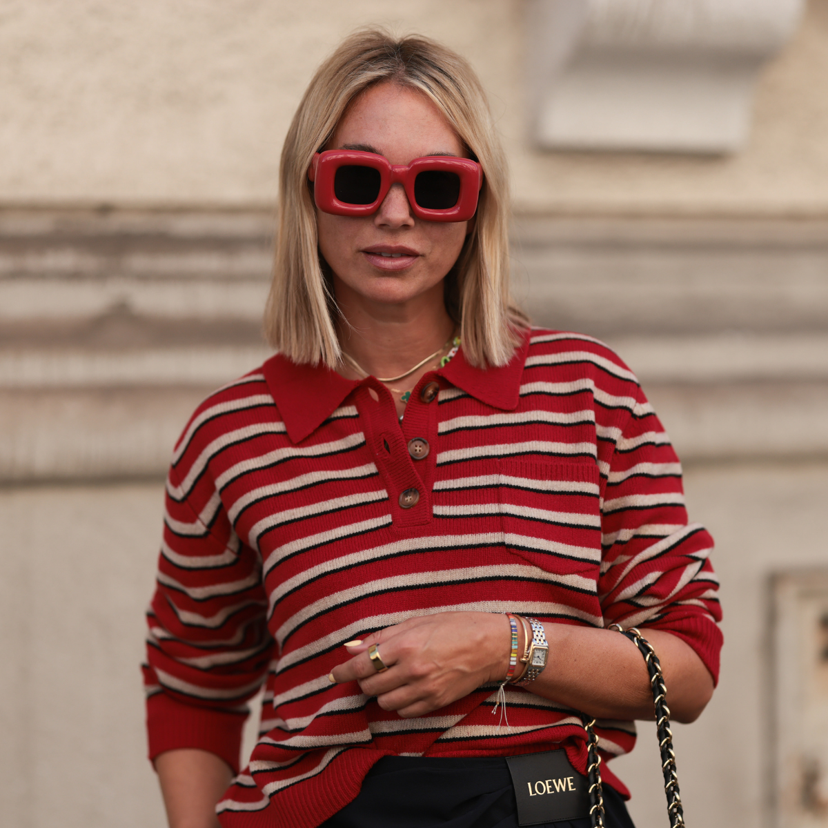 Post-summer hair repair Karin Teigl seen wearing Loewe red oversized square sunglasses, Baum &amp; Pferdgarten red-and-white striped long-sleeve polo sweater, colorful playful beaded necklaces including a cherry pendant, 