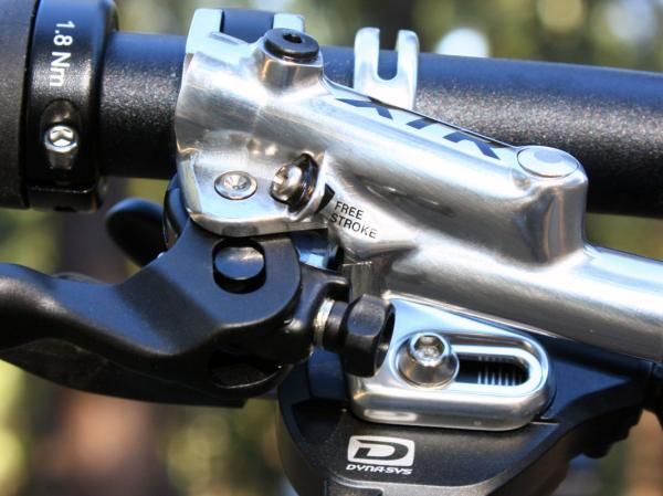 The 'Free Stroke' screw adjusts the top-out position of the master cylinder piston, effectively allowing users to customize lever throw.