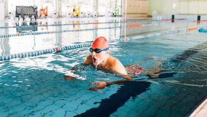 Senior man swimming in pool