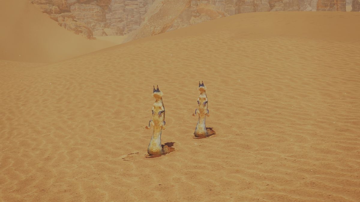 Two Track Tail Lizards in Monster Hunter Wilds standing out in the open sand. They&#039;re sitting propped up after just being frightened. 