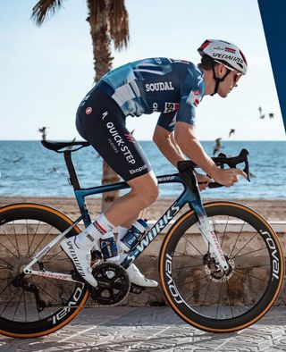 A rider in the 2025 quickstep team kit and bike