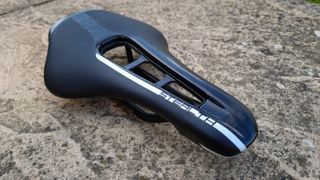 A close up of the Pro Stealth Carbon Saddle on a stone floor