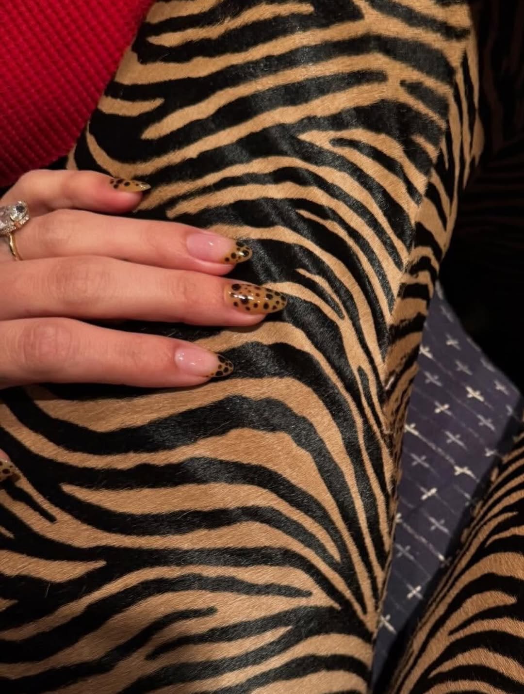 a person wearing leopard nails