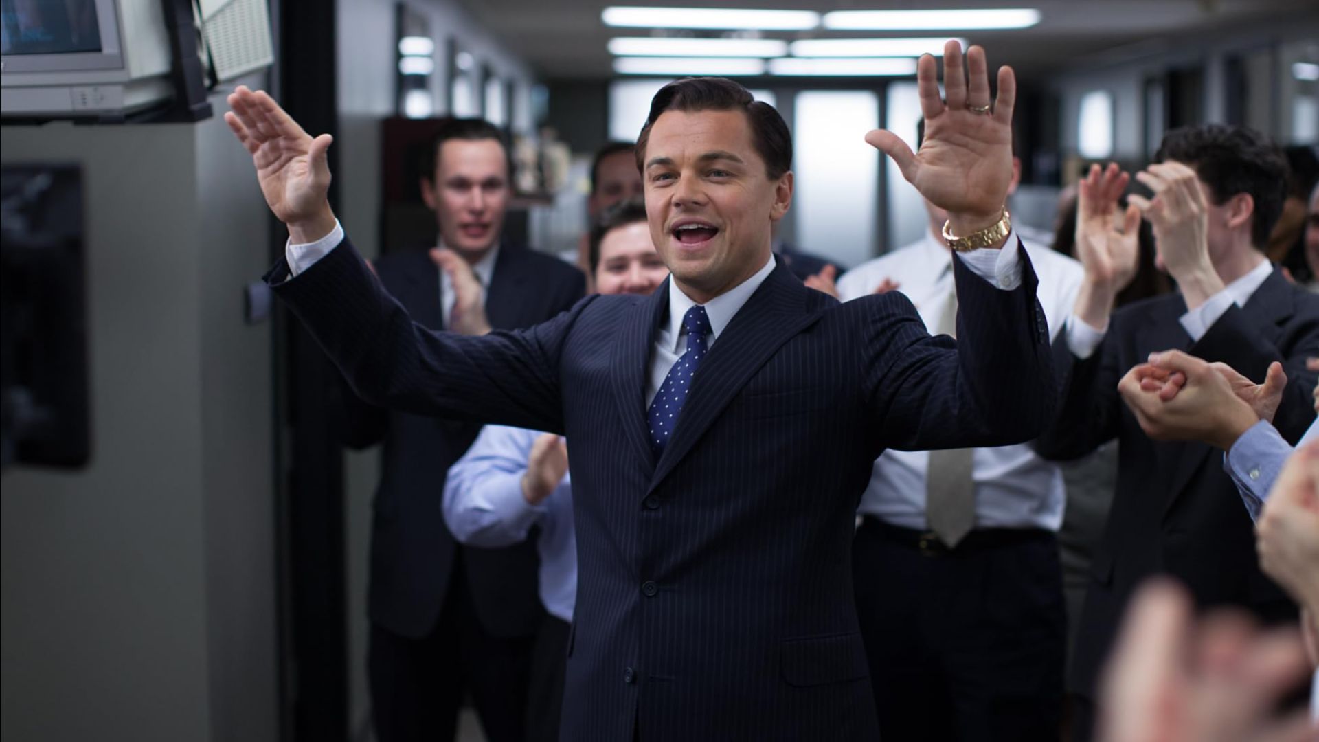 an image from wolf of wall st showing leonardo dicaprio in an armani suit