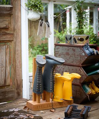 A boot rack with navy and yellow wellies and a vintage metal show rack illustrating storage ideas for garden sheds.